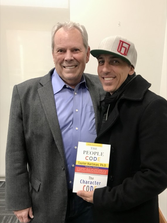 Tevya Wisdom Jones with Dr. Taylor Hartman, holding The People Code and The Character Code
