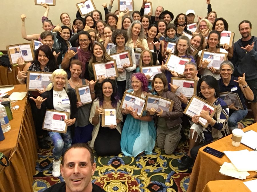A full room of Color Code workshop students holding their workbooks